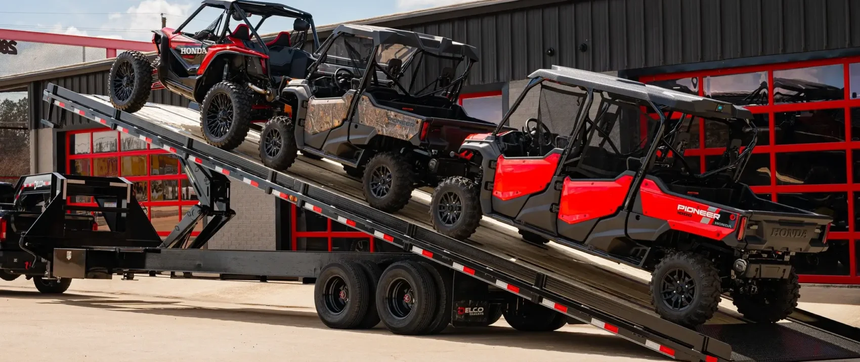 ATVs on a tiered trailer.