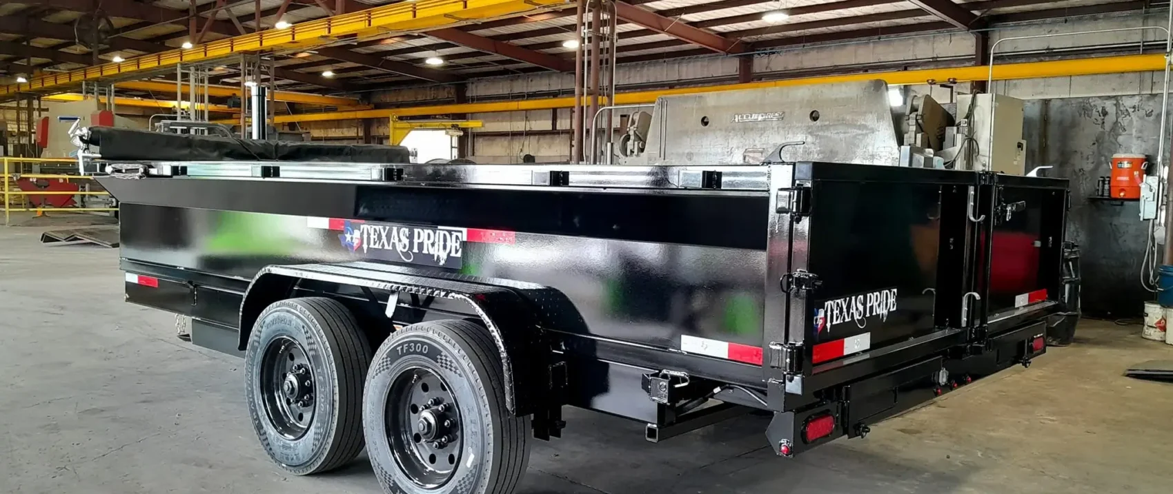 Black dump trailer indoors.